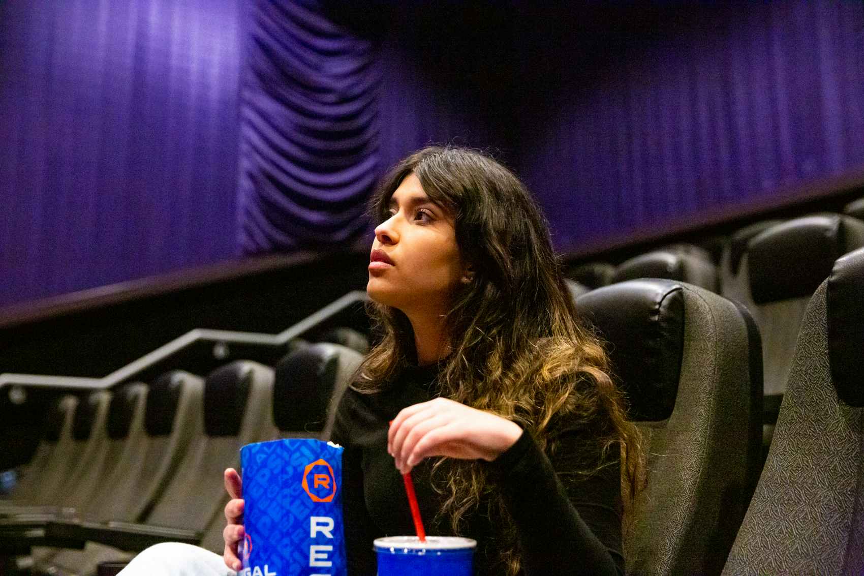 Woman watching a movie inside a theater