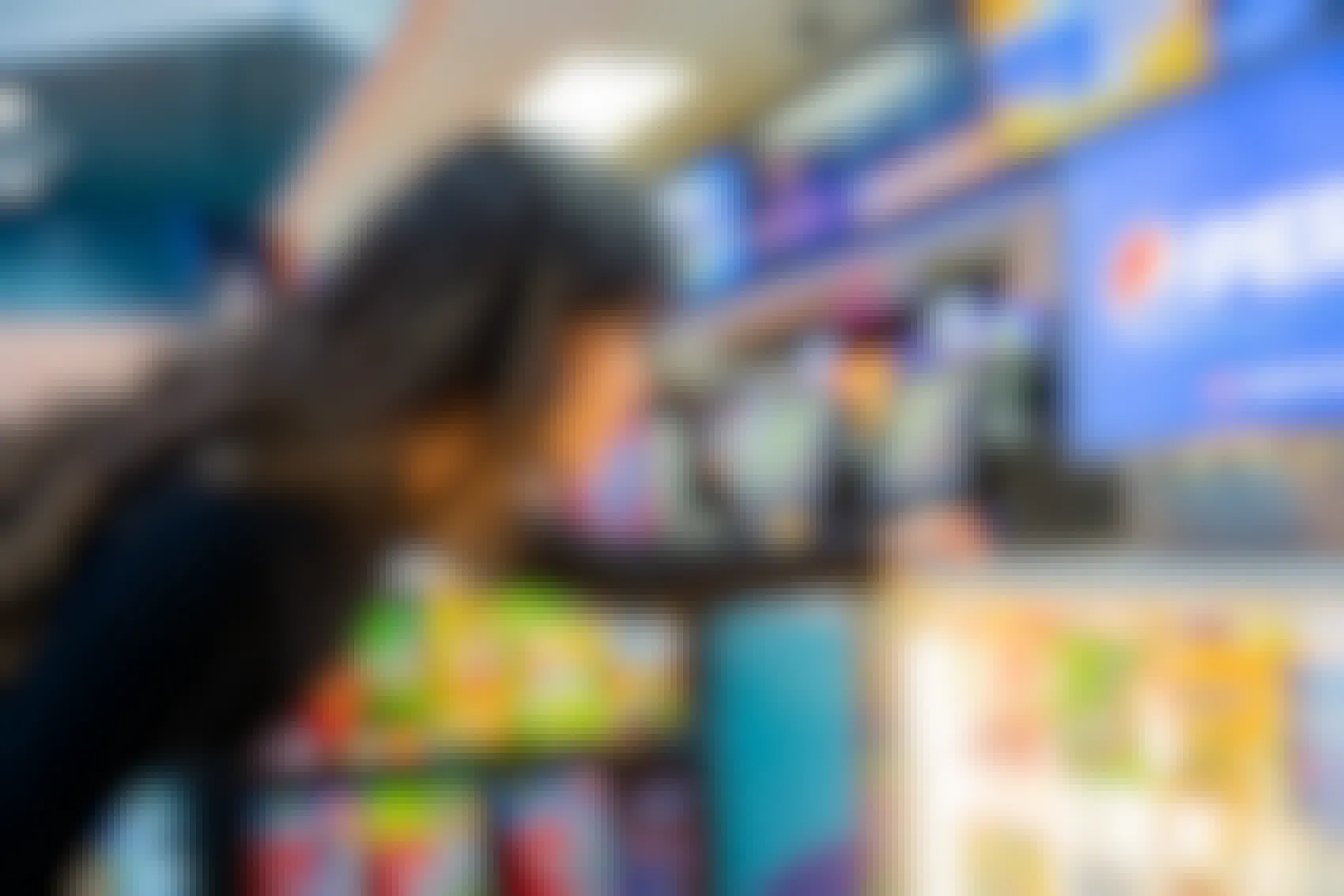 Woman looking at candy by the concessions stand inside Regal Cinemas