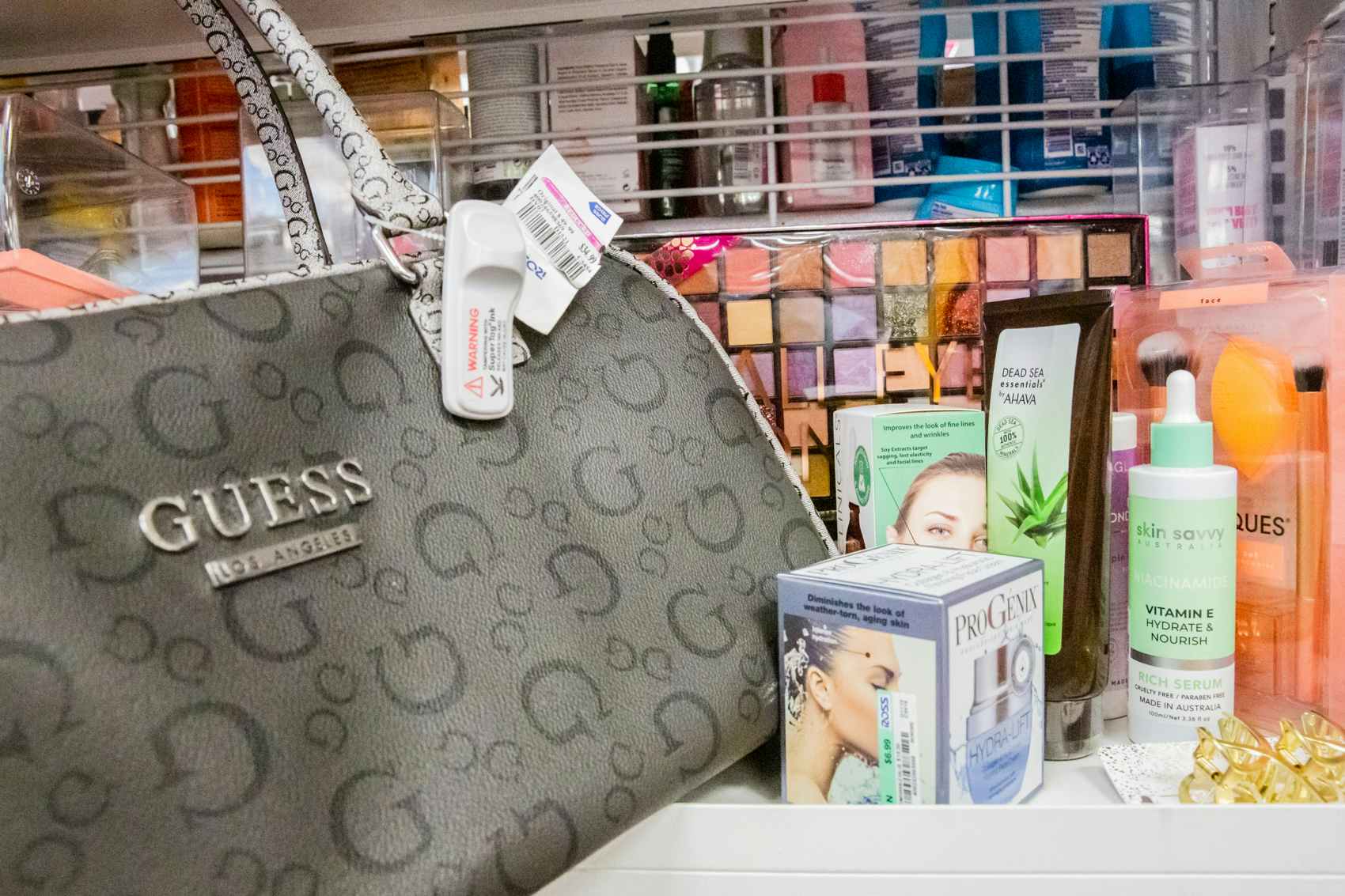 Guess Handbag with an assortment of beauty and hair care products