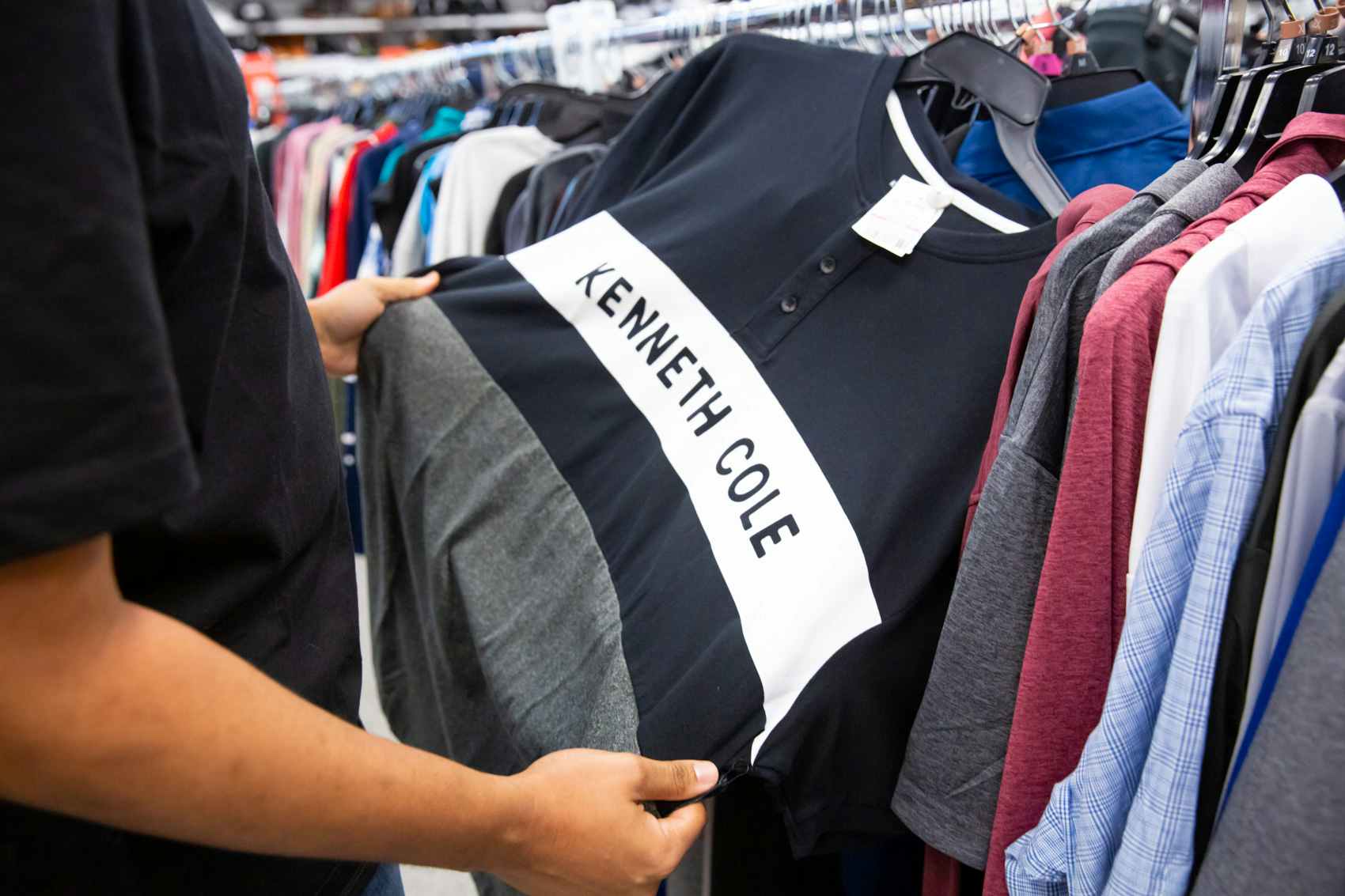 Person shopping with kenneth cole name brand shirt inside a ross