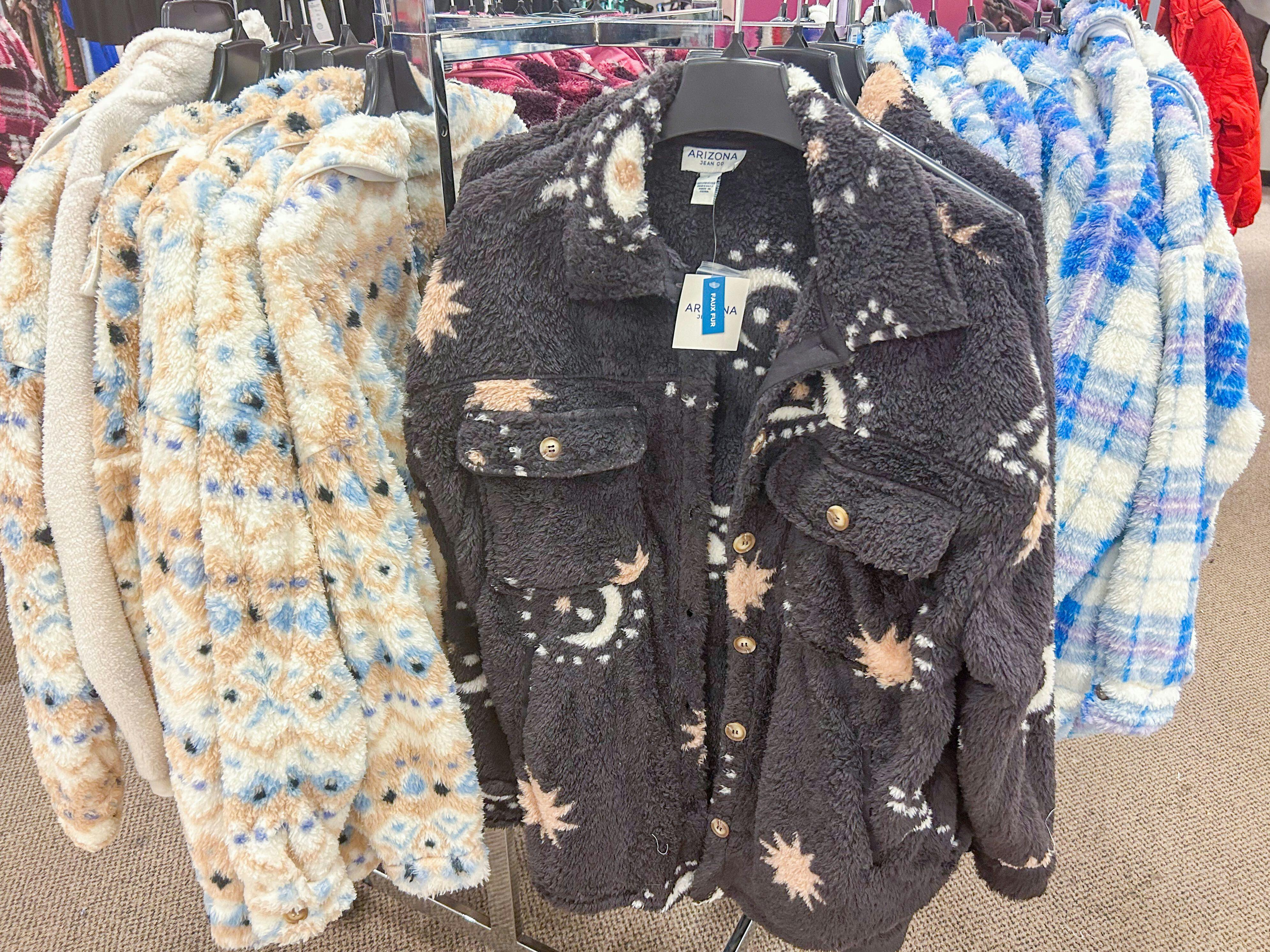 shirt jackets hanging on a rack for display