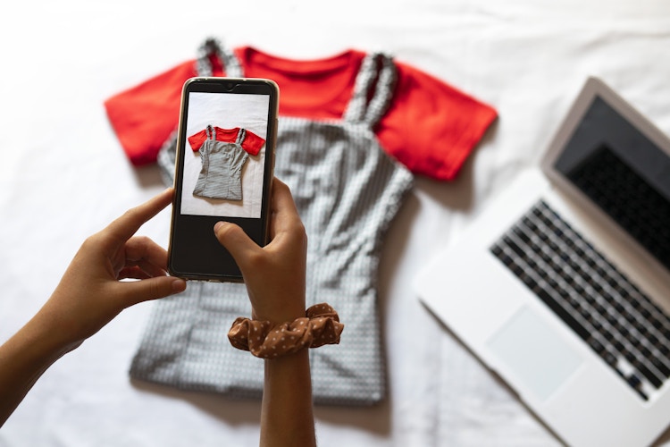 Person taking a picture of their clothes with their phone