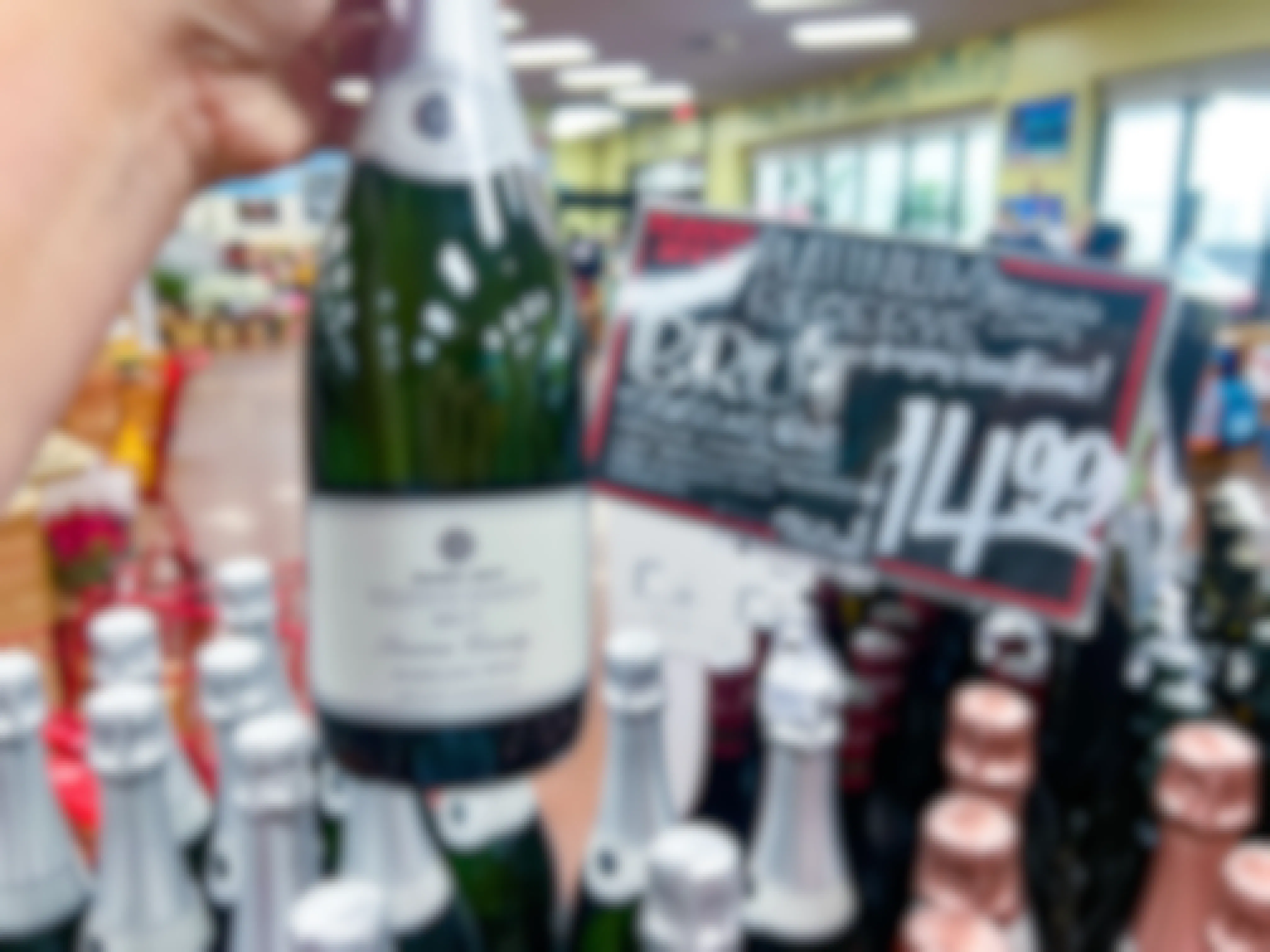 bottle of Trader Joe's Platinum Reserve Sonoma County Brut being held up in front of sign
