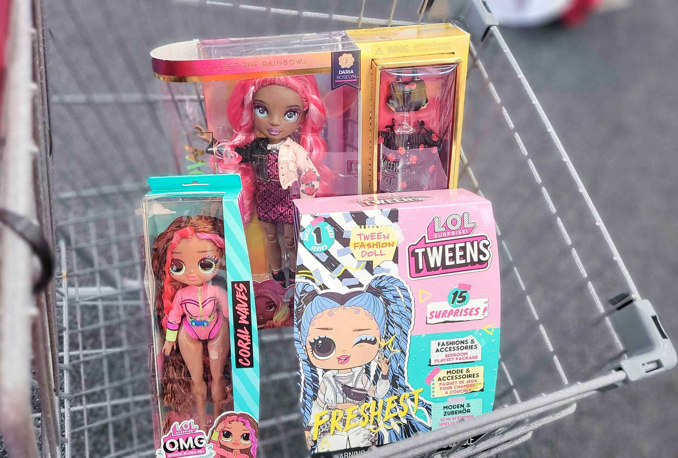 rainbow high and LOL dolls inside shopping cart