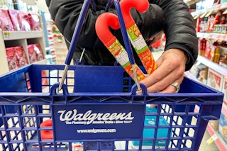 two reeses candy canes being put in walgreens basket