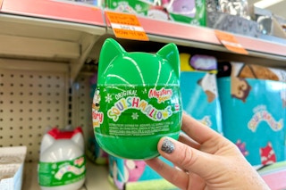 a squishmallow mystery egg being held in store
