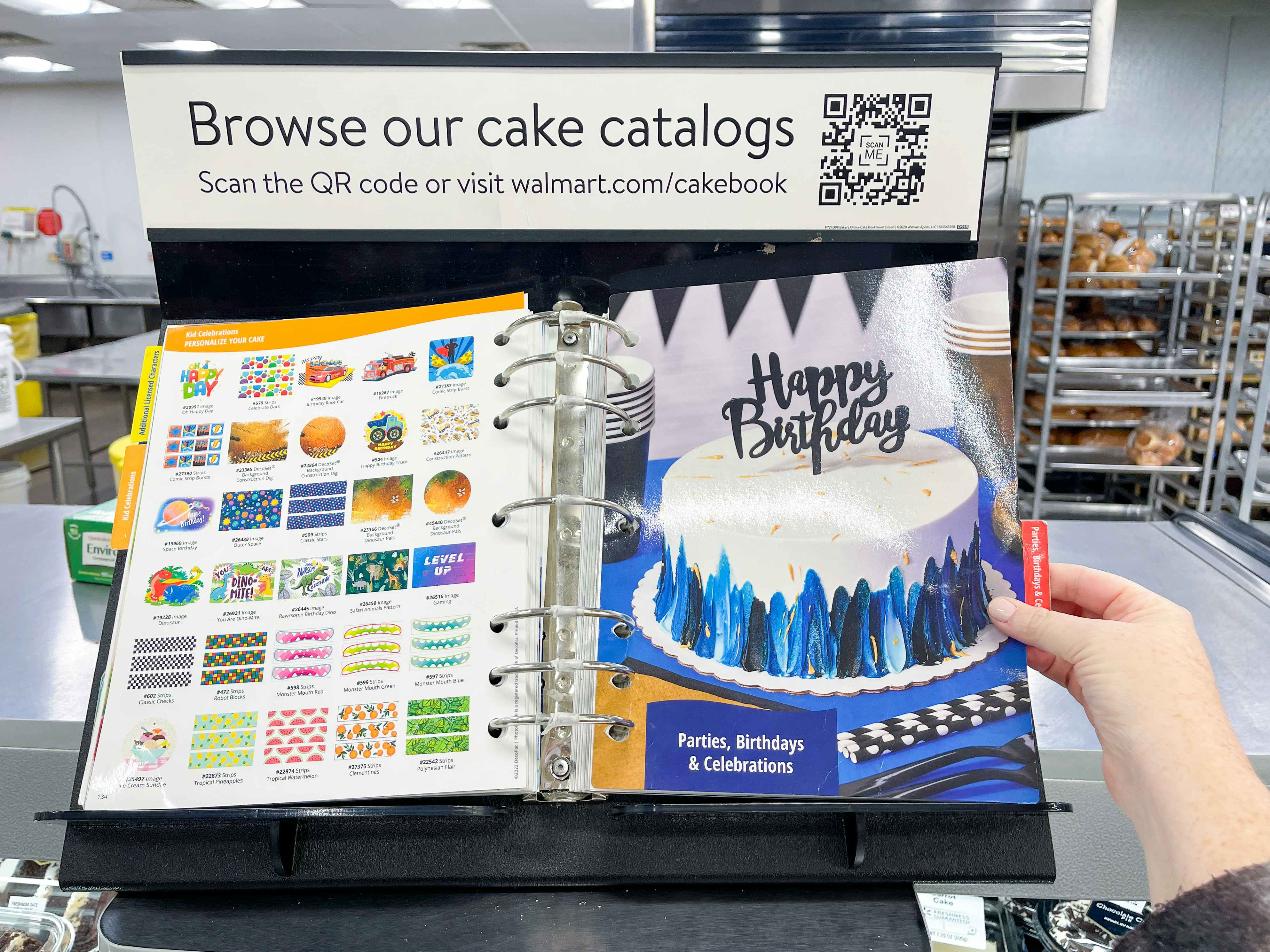 The custom cake catalog book on the counter in the Walmart bakery