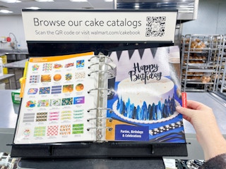 The custom cake catalog book on the counter in the Walmart bakery