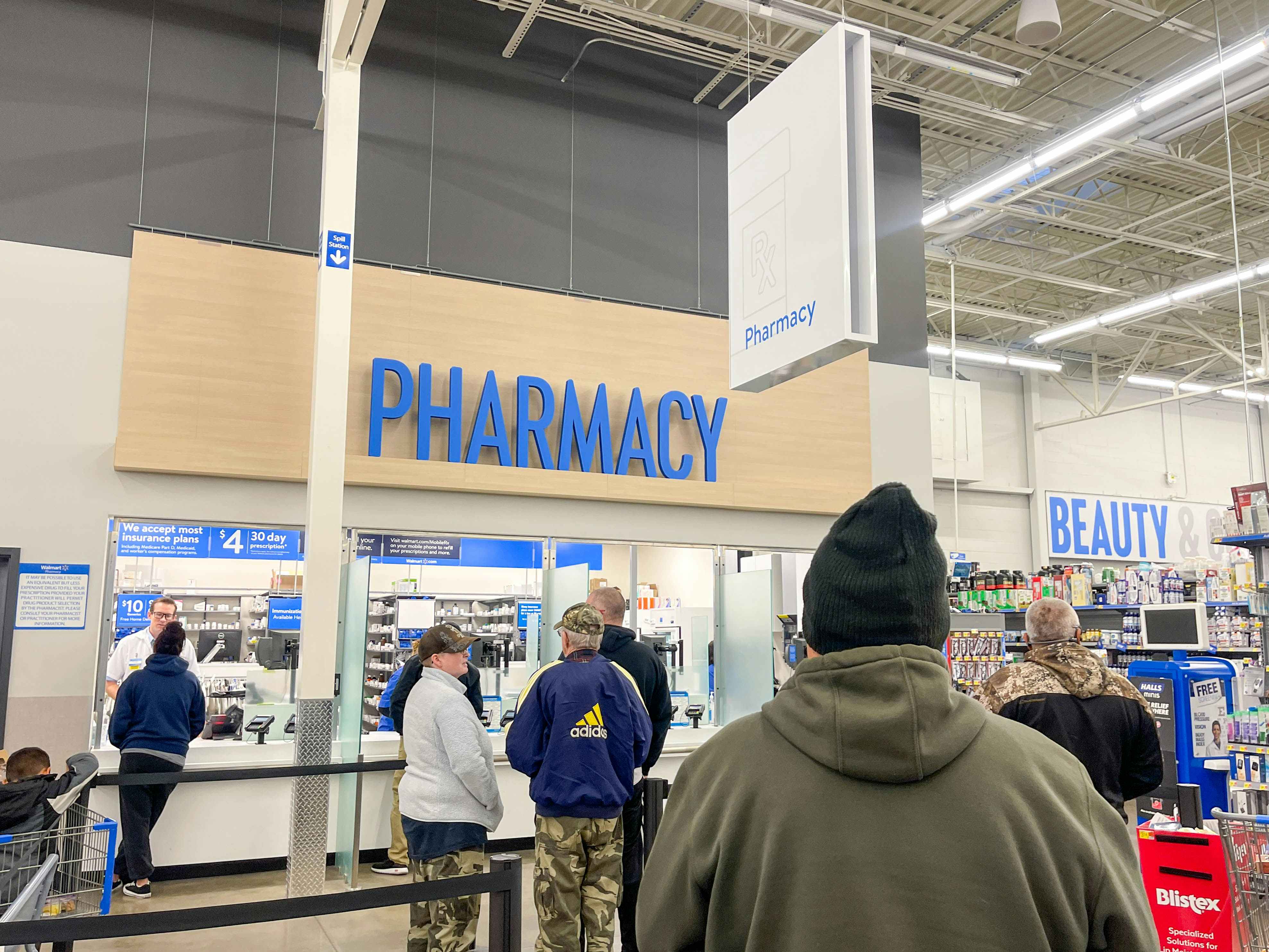 people standing in line at the walmart pharmacy
