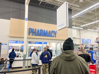 people standing in line at the walmart pharmacy
