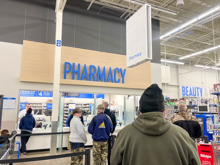 people standing in line at the walmart pharmacy