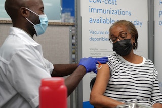 walmart pharmacist giving a woman an immunization shot