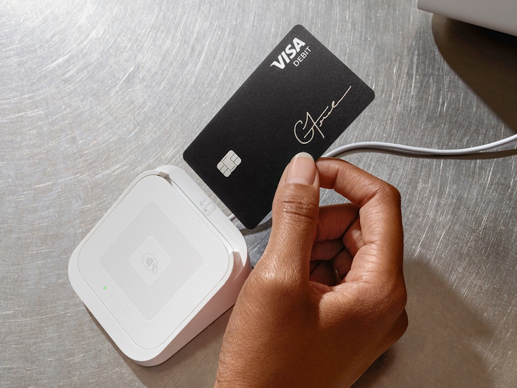 person swiping cash app visa card