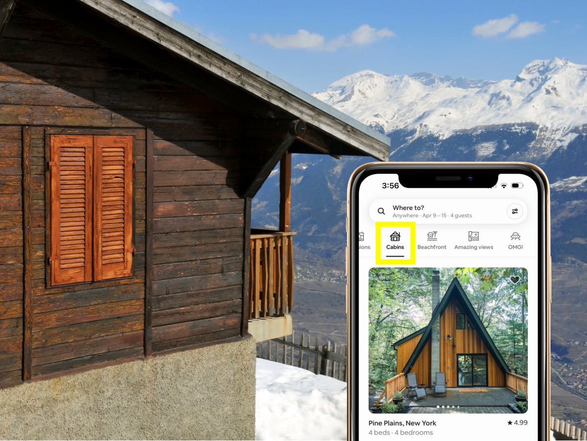 The upper half of a smartphone showing the airbnb app filtered to "cabins" with a cabin and mountain range in the background