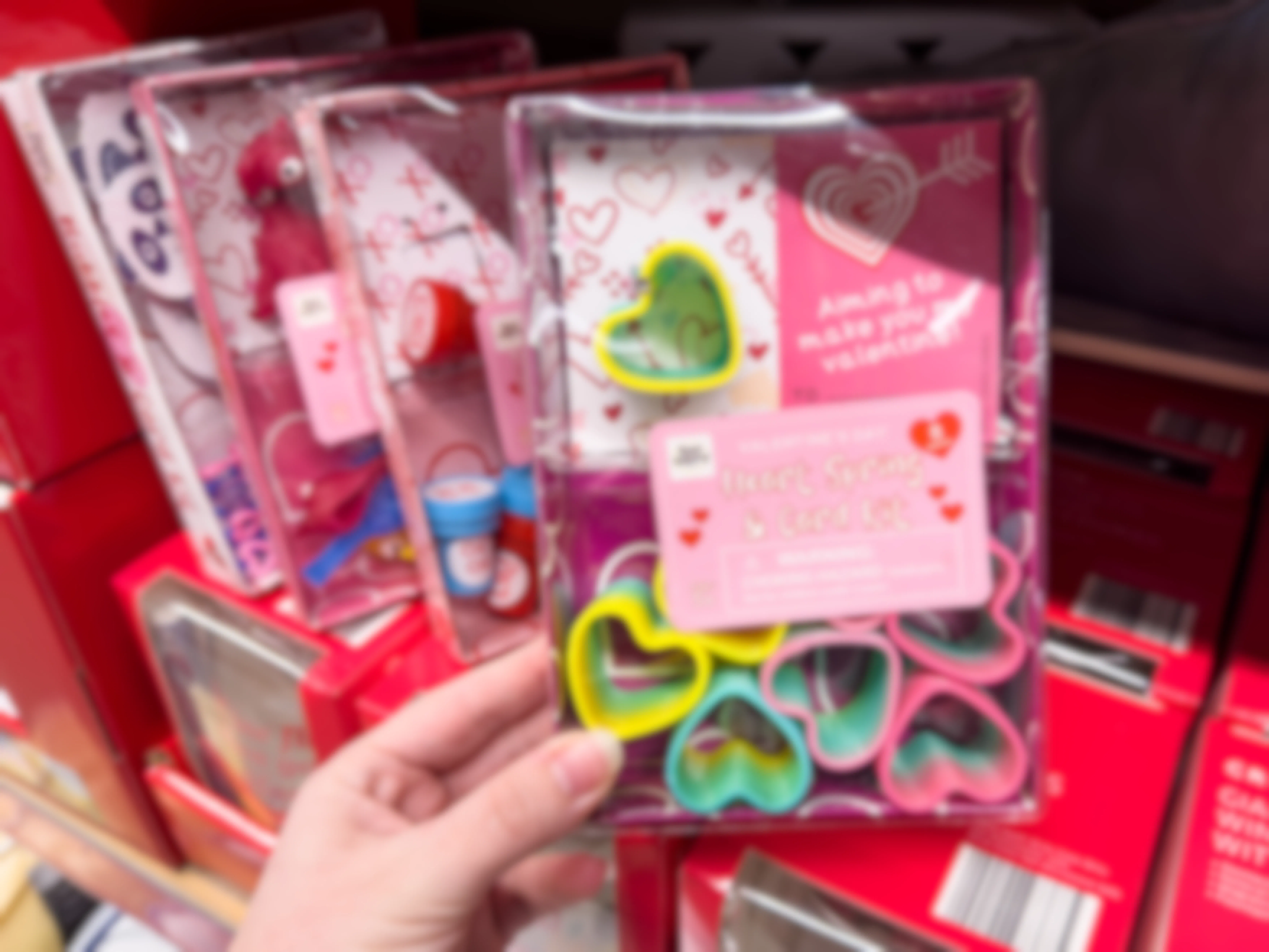 Someone holding a Heart Spring and card Valentine's Day kit at Aldi