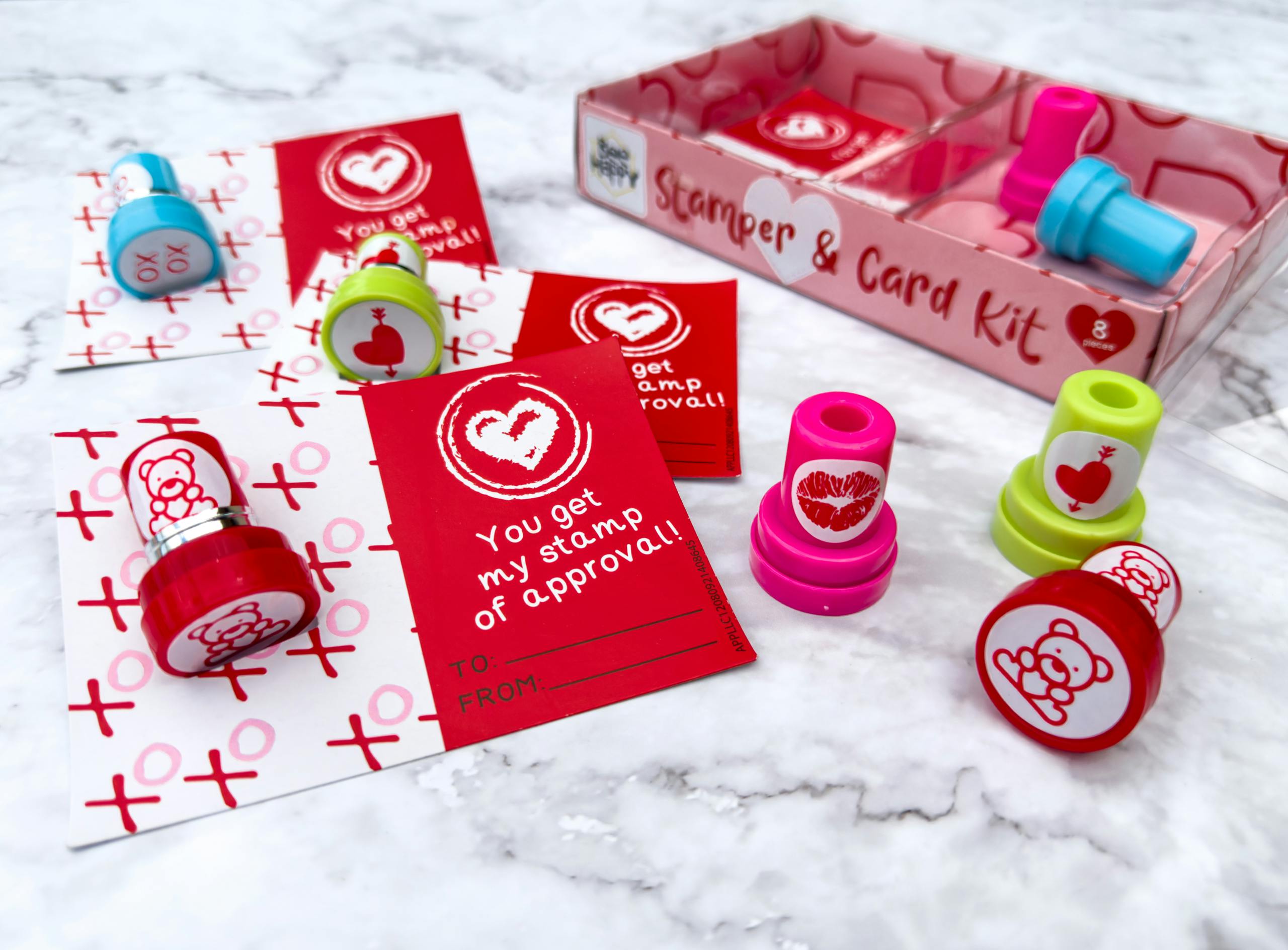 Someone working on putting together the cards from the Aldi Valentine's day Stamper kit on a counter