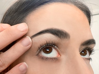 blending matte pink pencil just under eyebrow arches