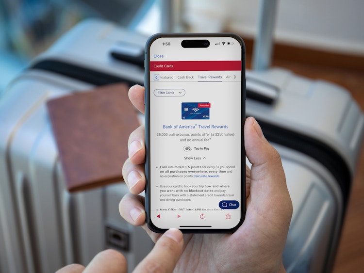 Person holding a phone with the bank of america travel card details being shown