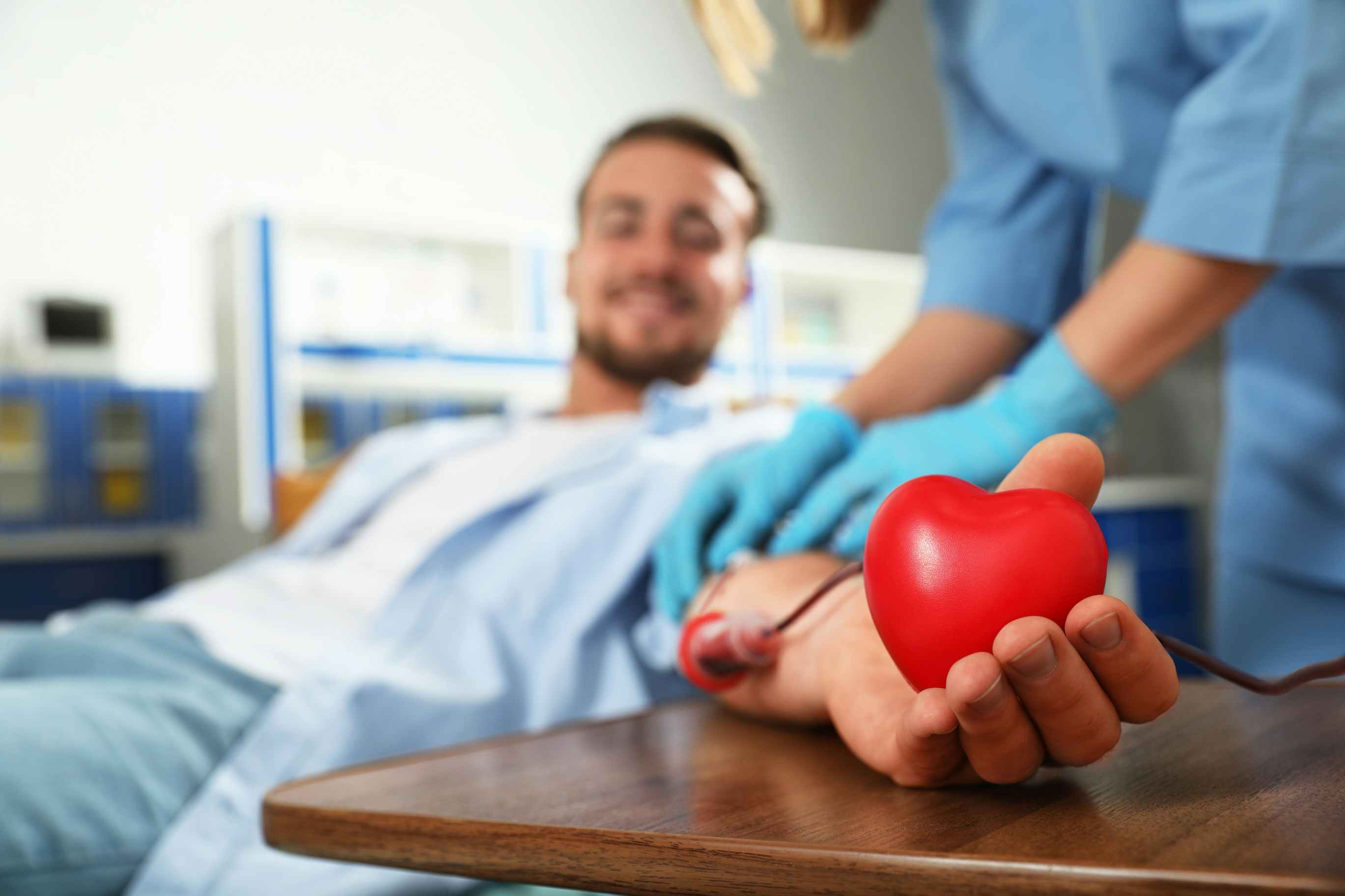 Person holding a stress ball while donating blood