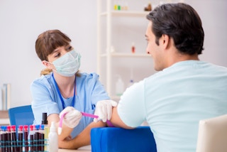 Nurse doing a blood donation on a young