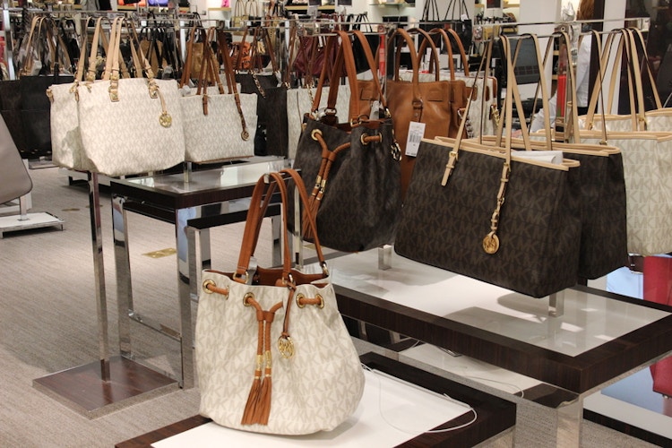 michael kors handbags hanging in store