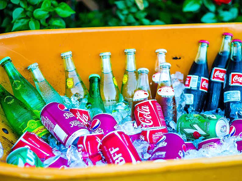 soda and sparkling water kept cold in a wheelbarrow full of ice