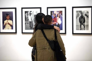 A couple walking through an exhibition at the Bronx Museum