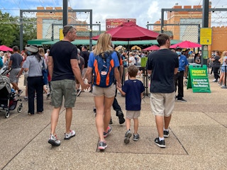 A family walking together to the entrance of Busch Gardens in Tampa, Florida