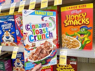 hand holidng up cereal box in cereal aisle at Walgreens