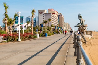A view of the Virginia Beach boardwalk showing hotels like the Hamptonn Inn, Residence Inn, and other hotels along the shore