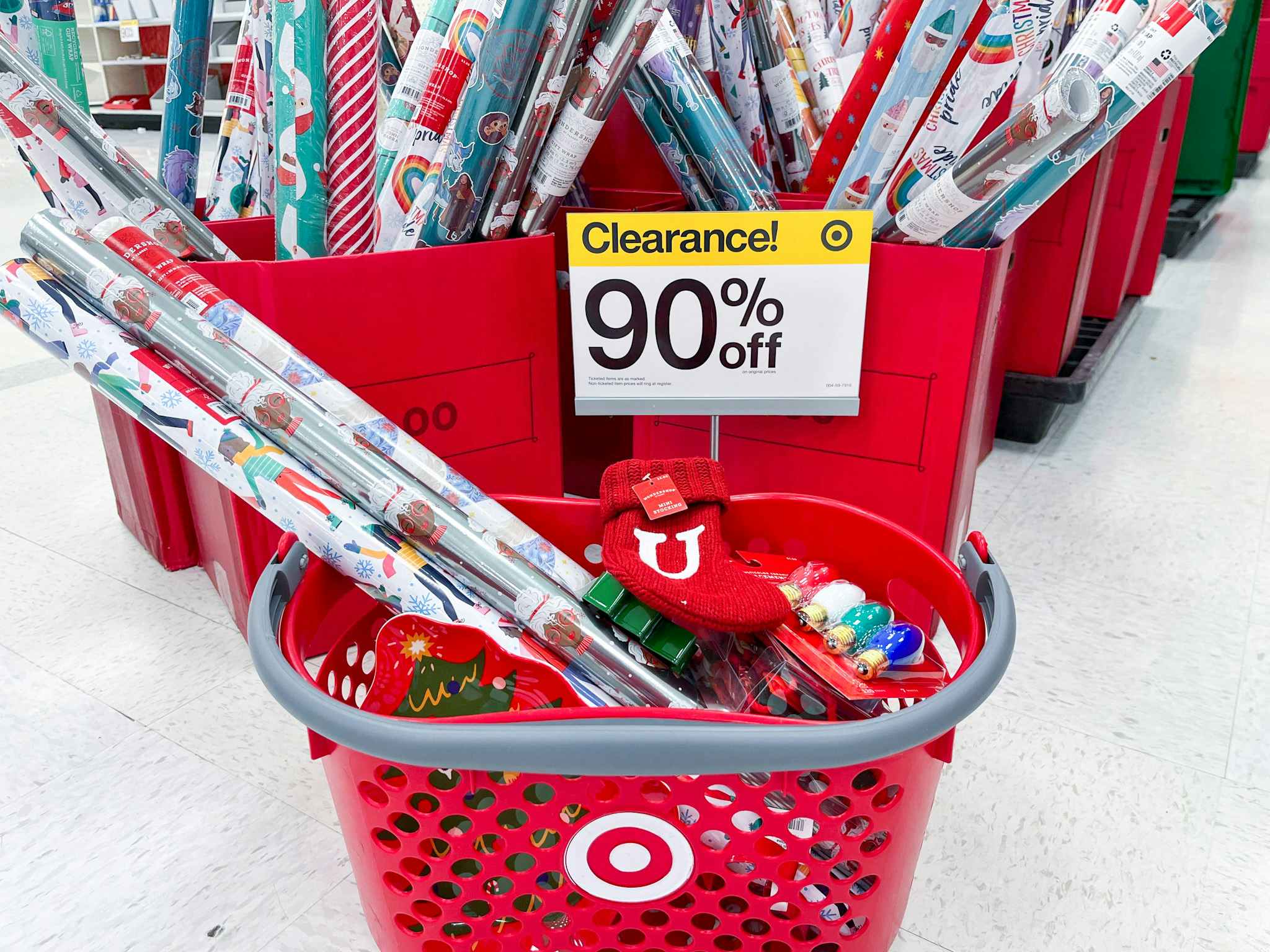 a target backed with chrismtas items in front of a 90 percent off sign in store 