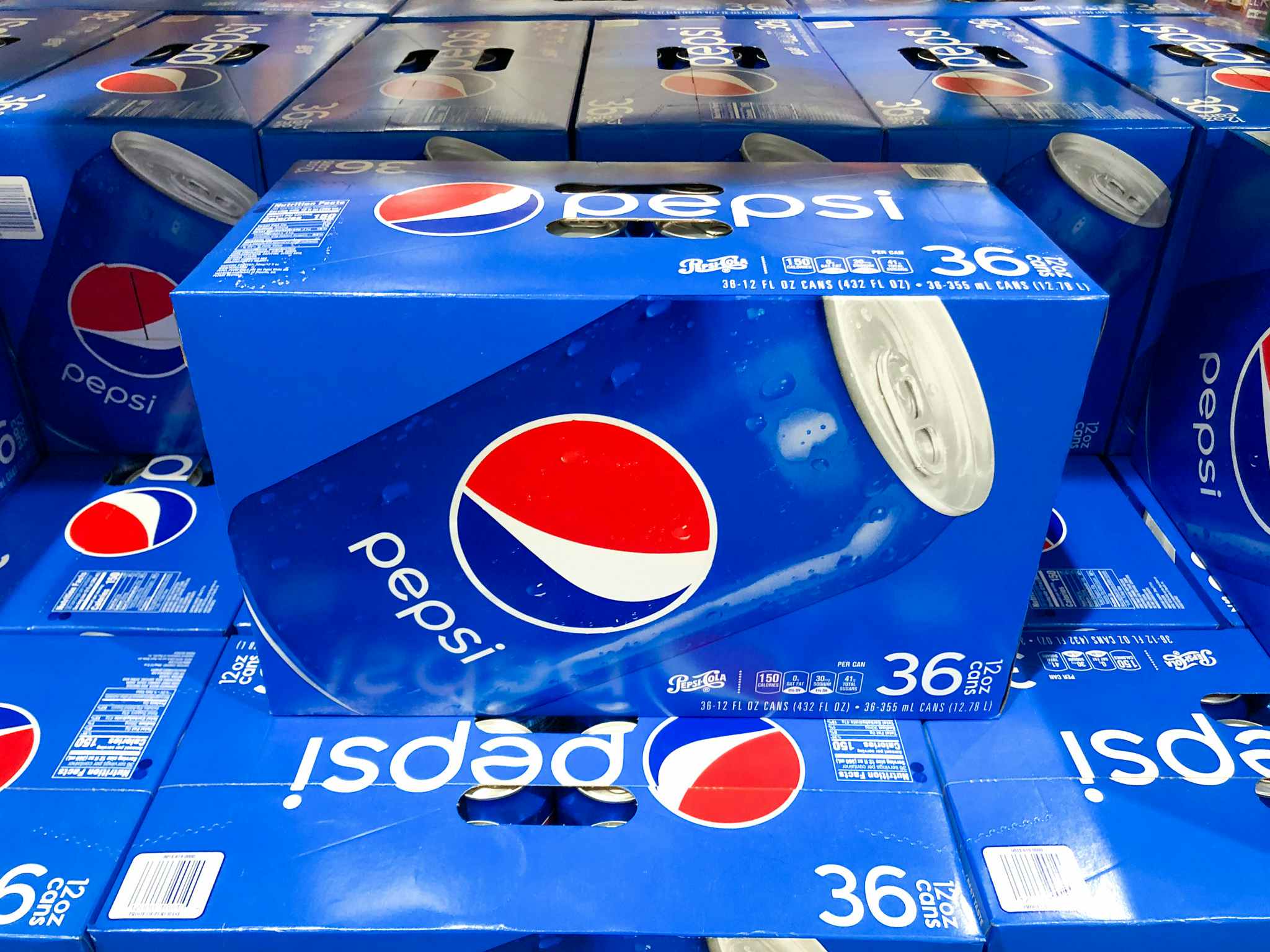a box of pespi stacked on other boxes of pepsi
