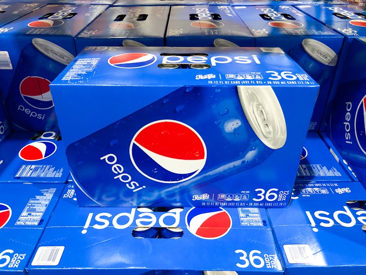a box of pespi stacked on other boxes of pepsi