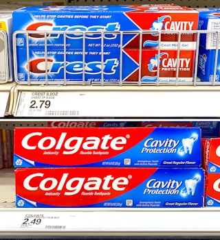 2-up of colgate and crest cavity protection toothpaste with prices on target shelves