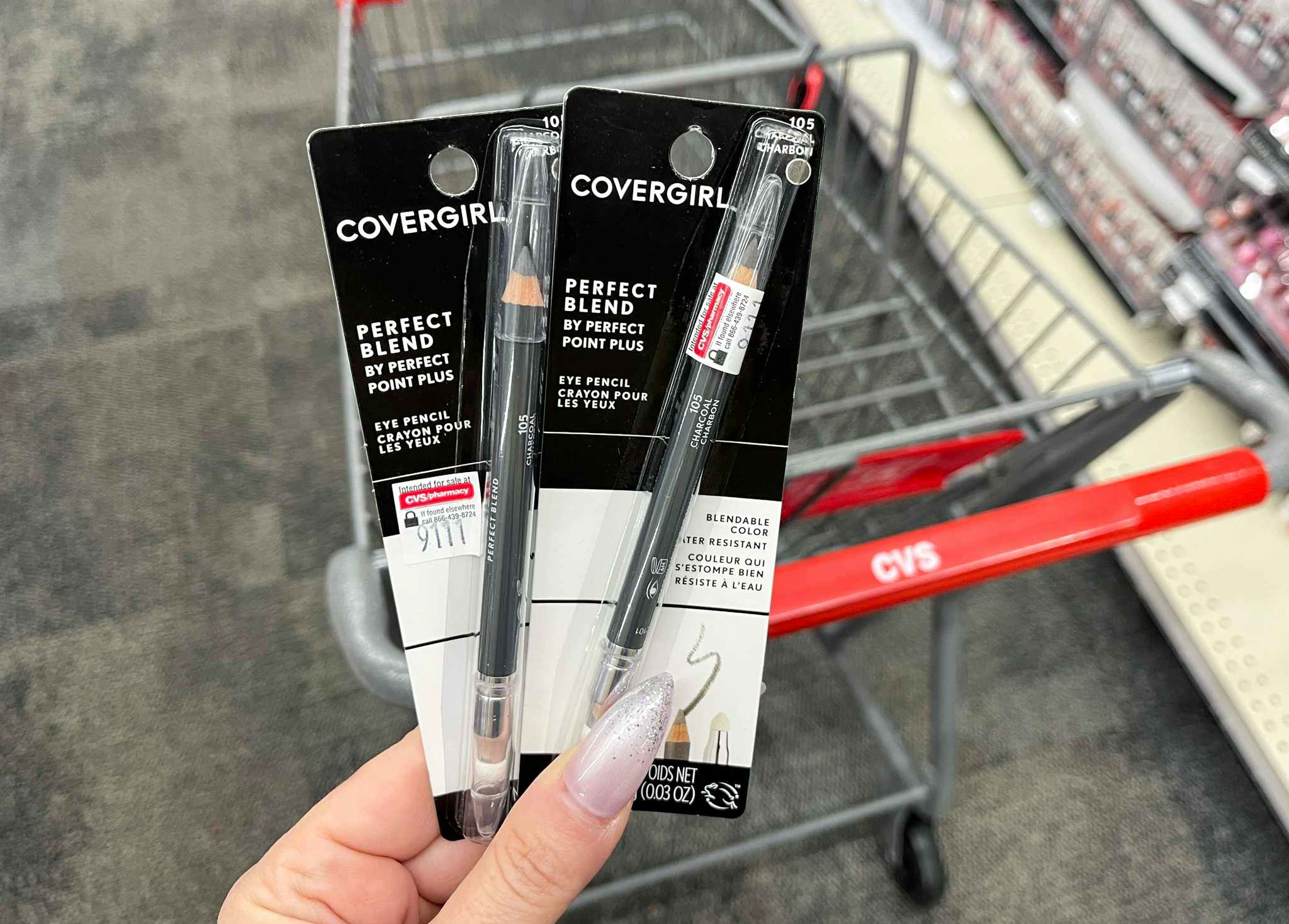 hand holding two packs of Covergirl Perfect Blend Eye Pencils