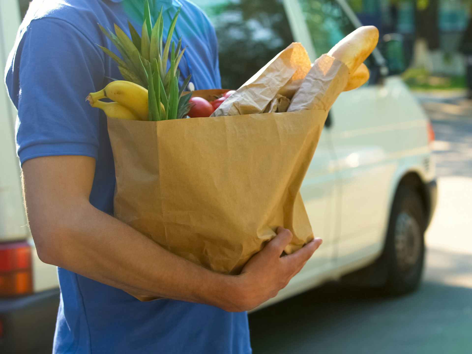 person holding a grocery delivery order