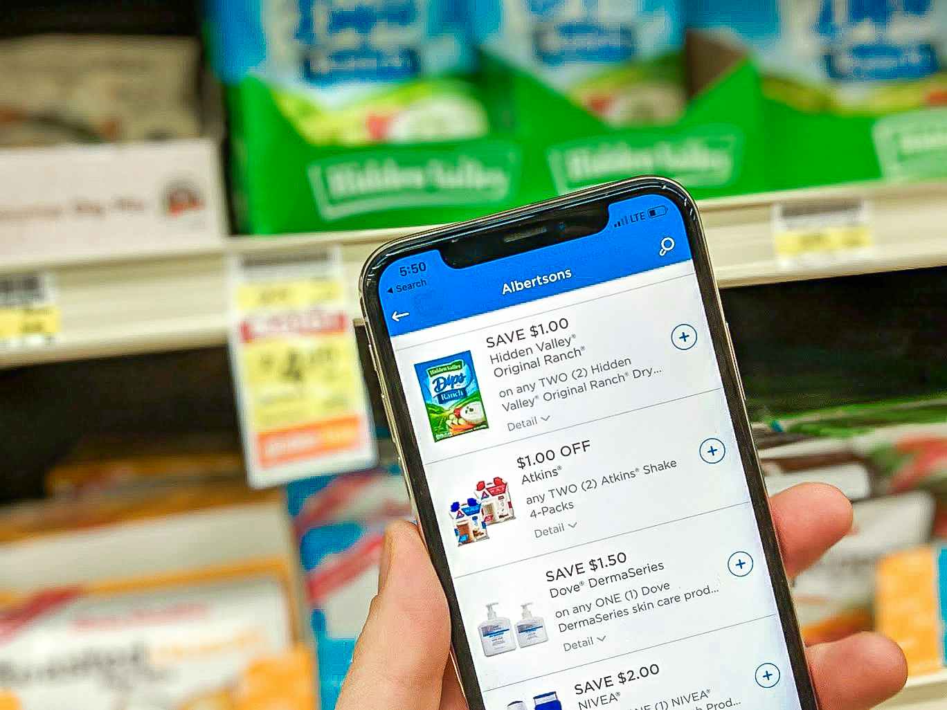 Someone looking at the Albertsons app while shopping