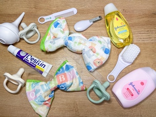 baby items on a table to make a diaper wreath