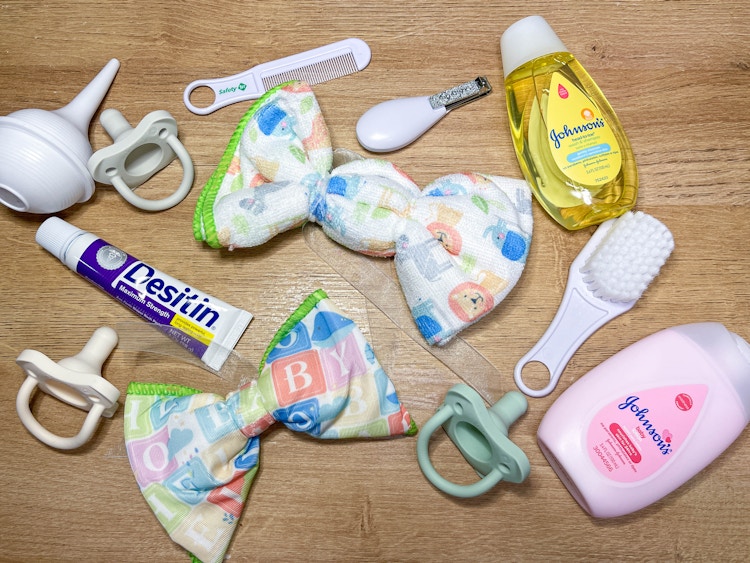 baby items on a table to make a diaper wreath