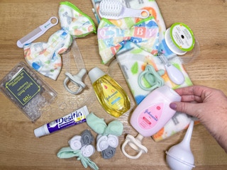 baby items on a table to make a diaper wreath