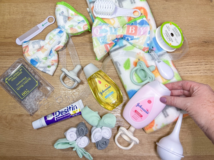 baby items on a table to make a diaper wreath