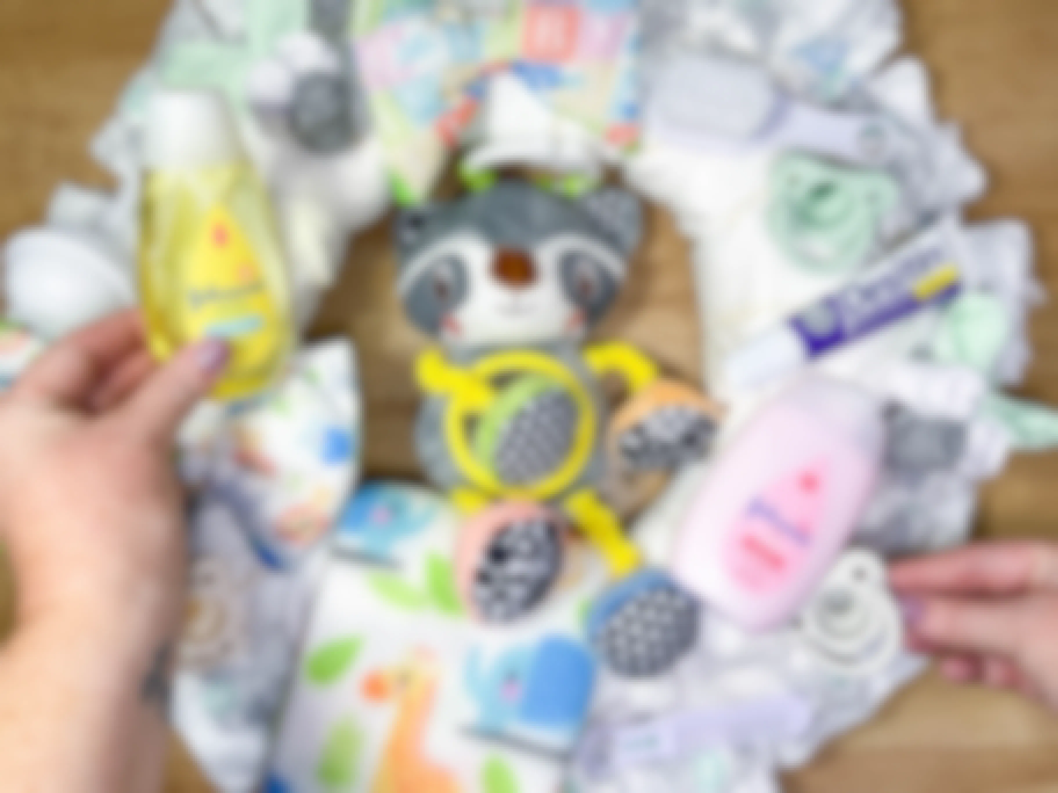 baby items being placed on a diy diaper wreath
