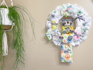 diy diaper wreath hanging on wall