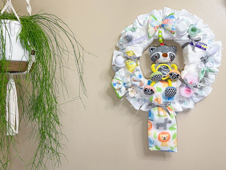 diy diaper wreath hanging on wall