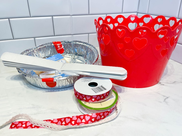 supplies to make a diy cupcake valentine sitting on a counter