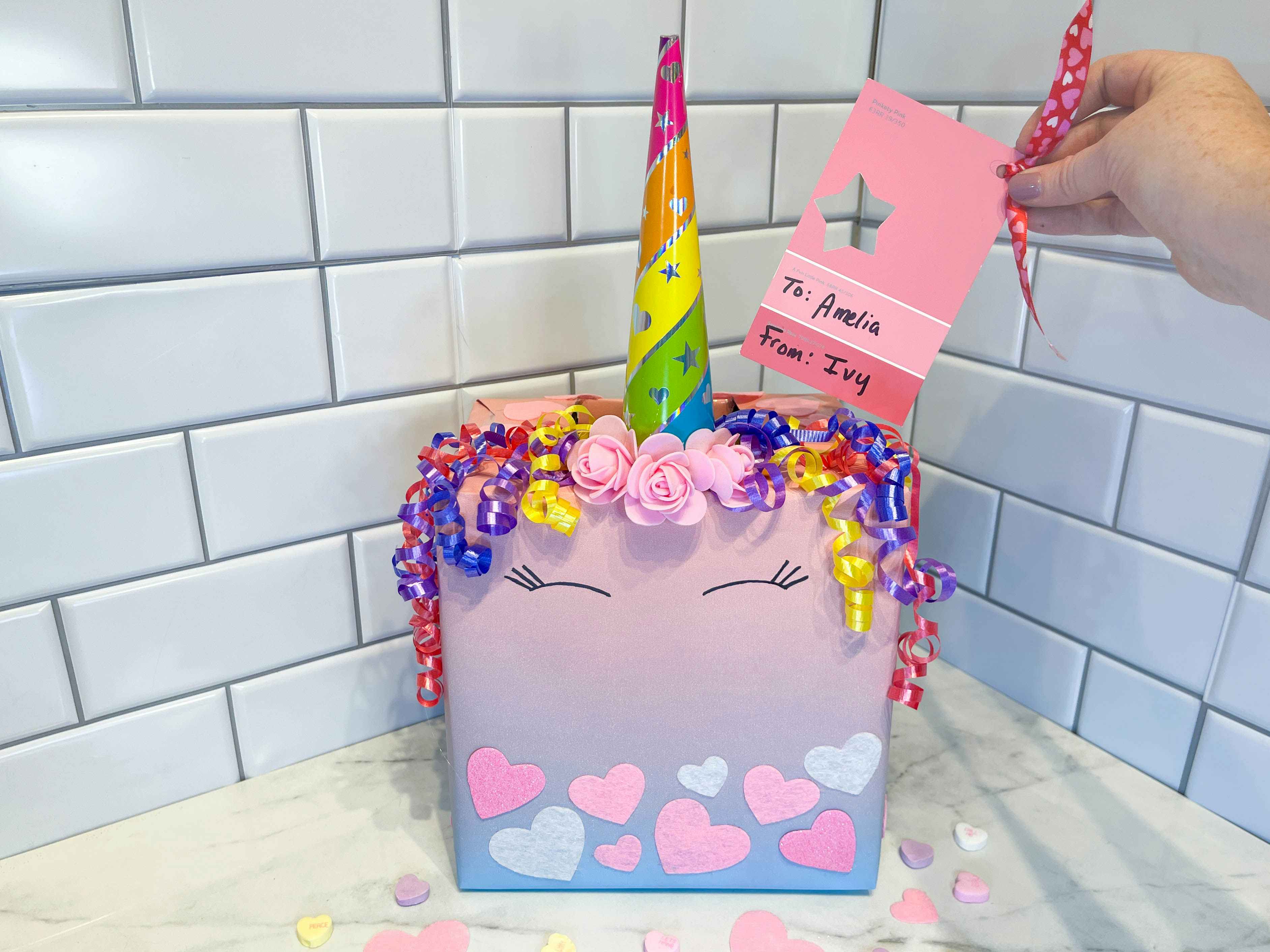 a diy unicorn valentine sitting on a counter