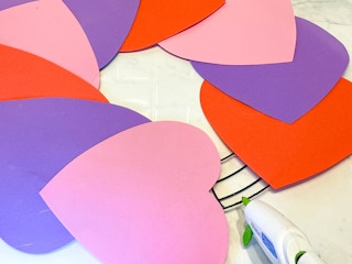 a foam heart diy wreath being glued