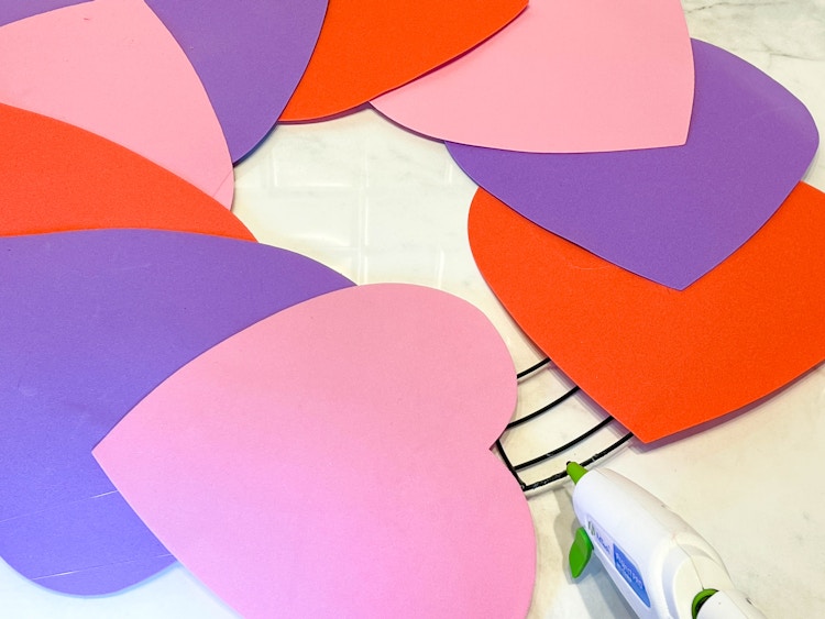 a foam heart diy wreath being glued