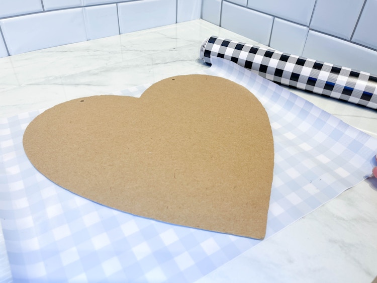 a wood heart about to be covered in vinyl 