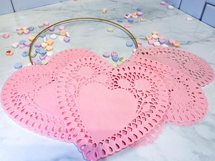 a heart paper doilies on a counter 